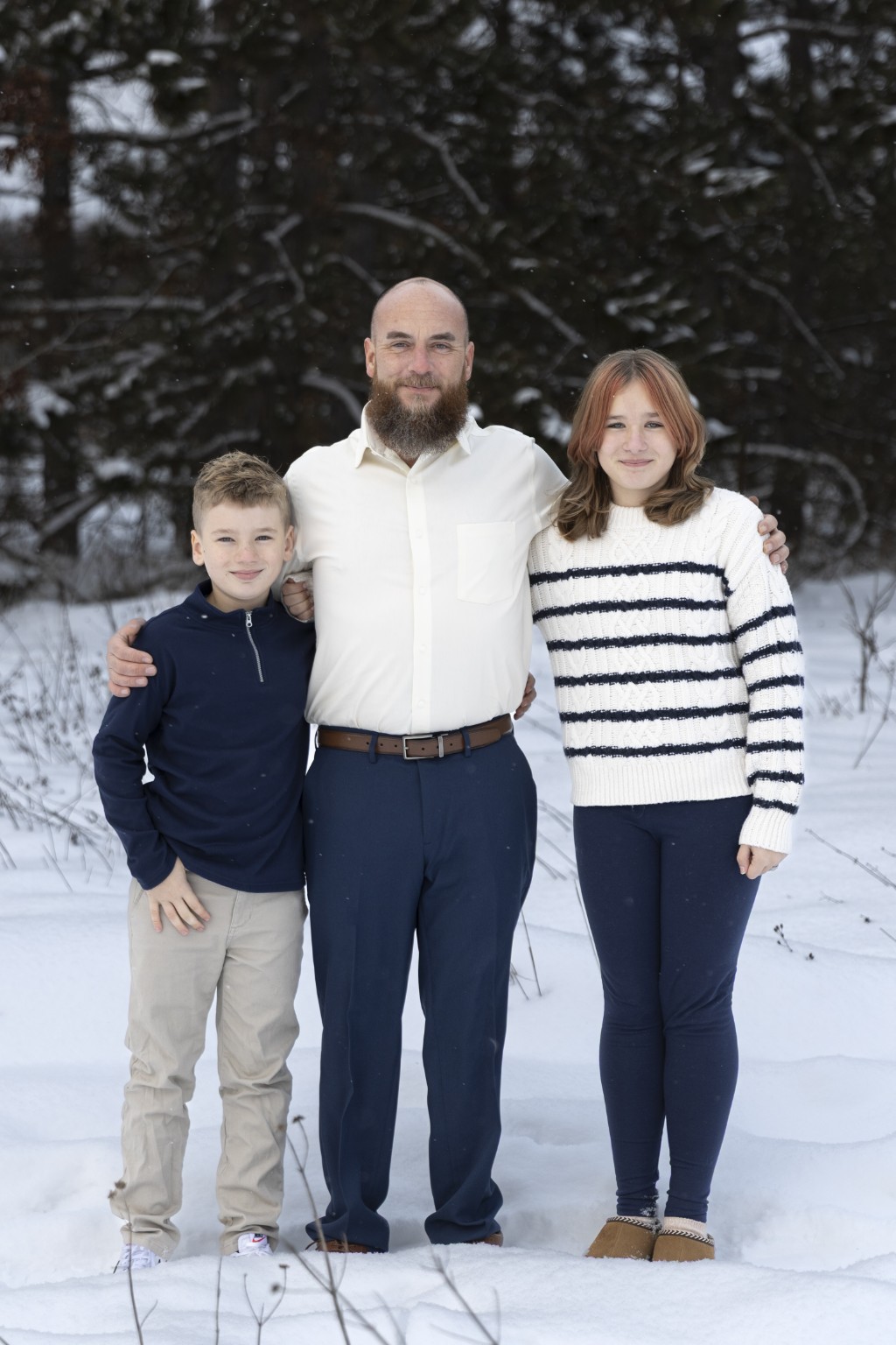Matt Newton with his two children outdoors in the snow